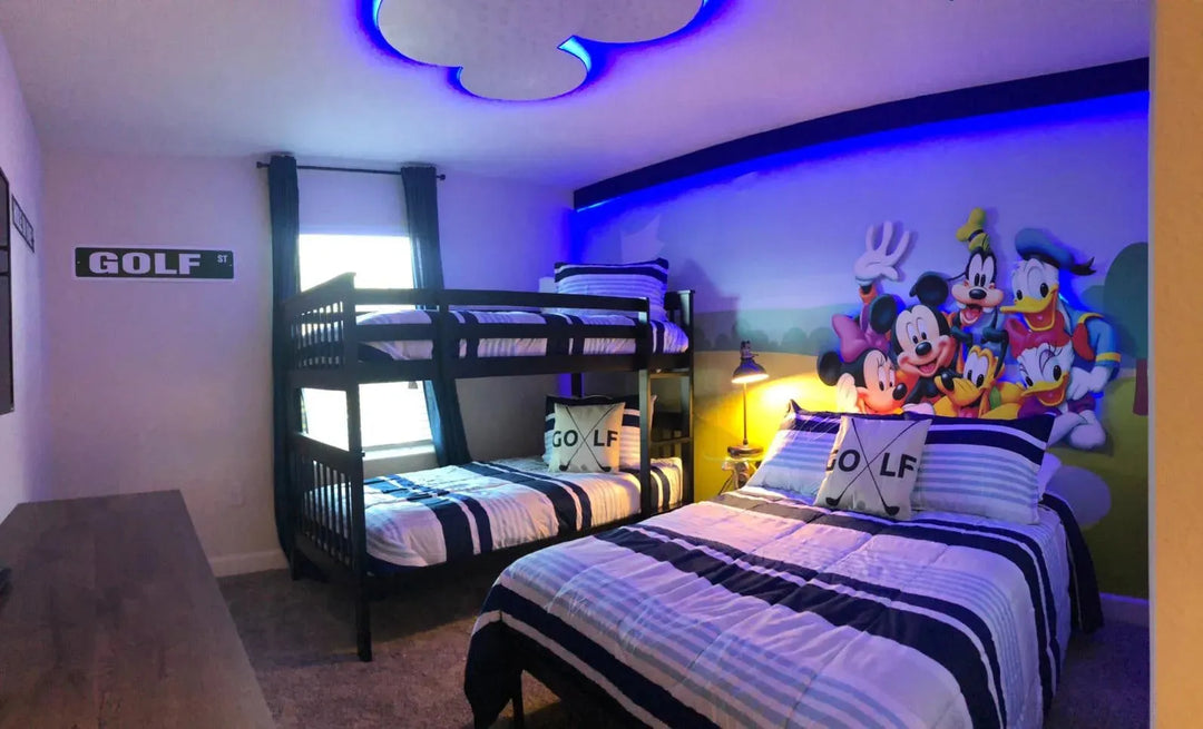 Disney World themed bedrooms with Mickey and Friends Theme. Really cute bedroom with a double and a bunk bed.